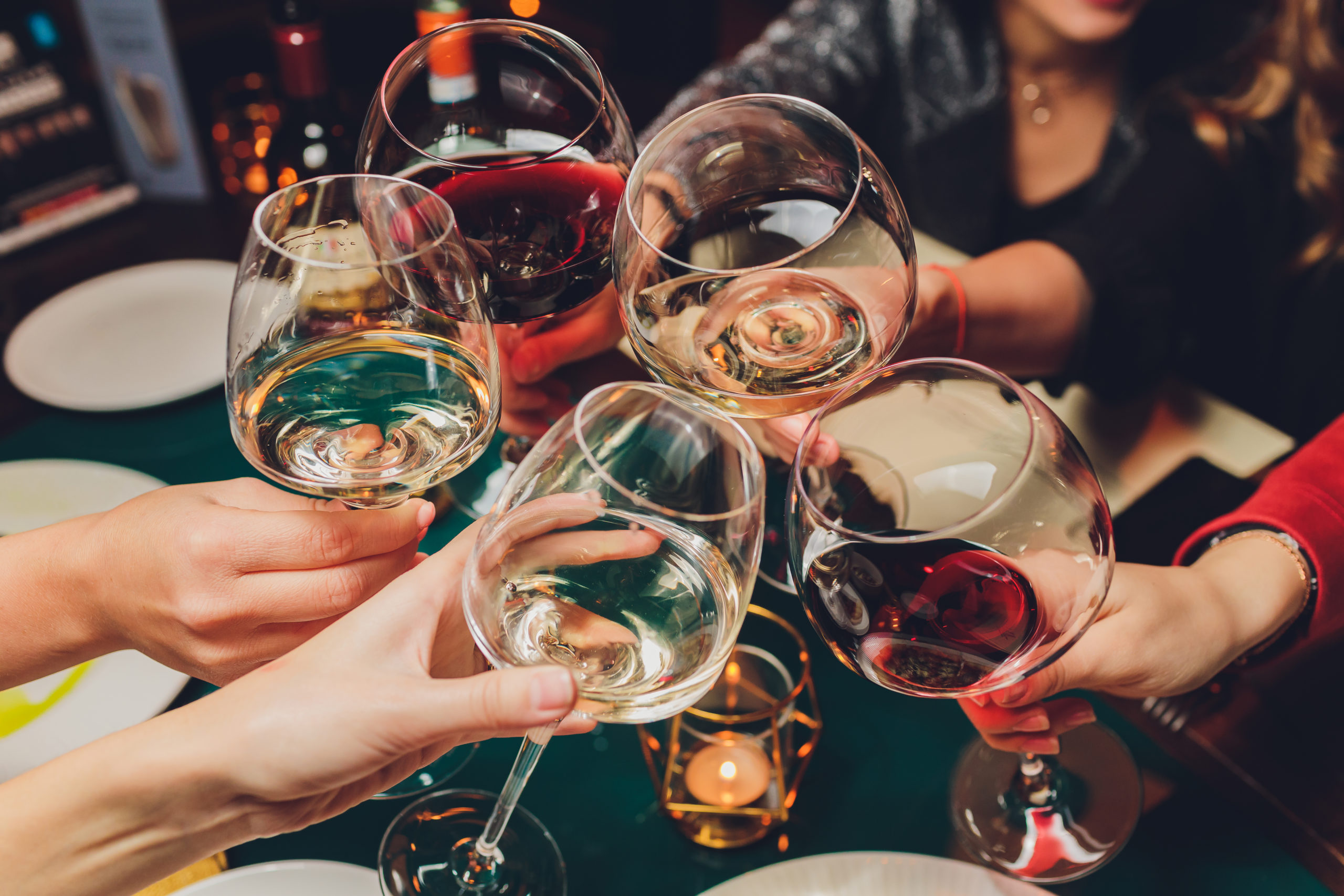 Clinking glasses with alcohol and toasting, party.